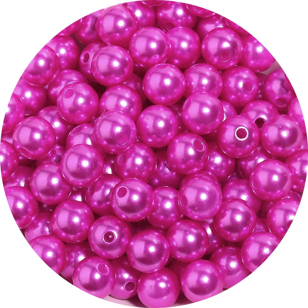 A pile of pink and purple imitation pearl beads for DIY jewelry making