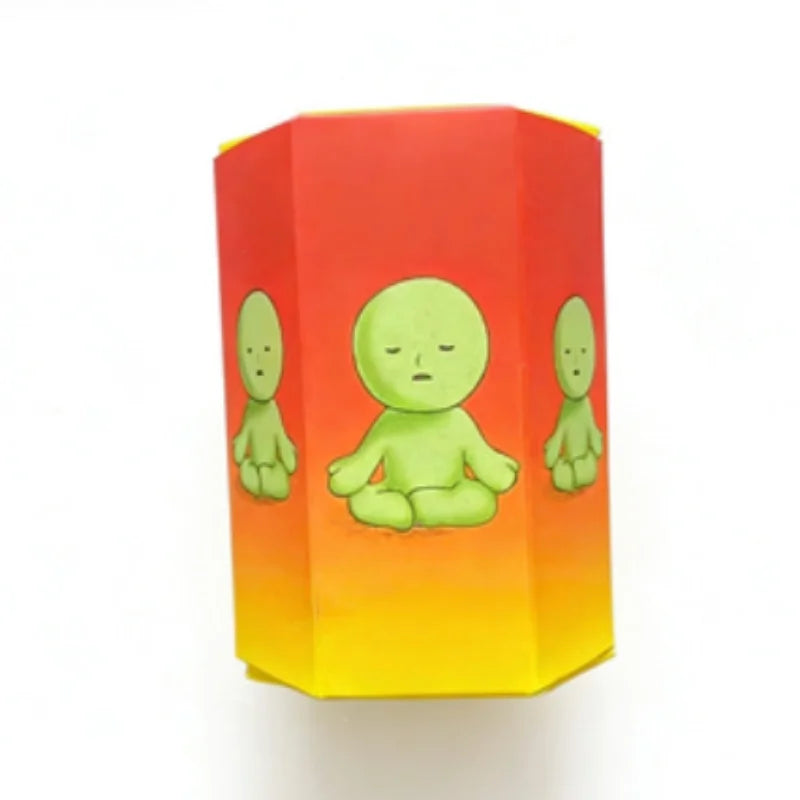 A glow-in-the-dark blind box collectible featuring three green elf figures inside a red and orange cardboard container.