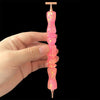A hand holds a glitter resin diamond painting pen with a sparkle wavy handle, showing the pink translucent product.