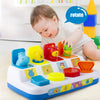 A baby is interacting with a colorful pop-up animal toy game featuring various shapes and colors.