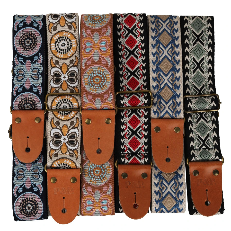 A collection of embroidered guitar straps featuring various patterns and leather ends.