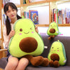 A cute, bright green avocado plush toy with brown accents is being held by a young woman.