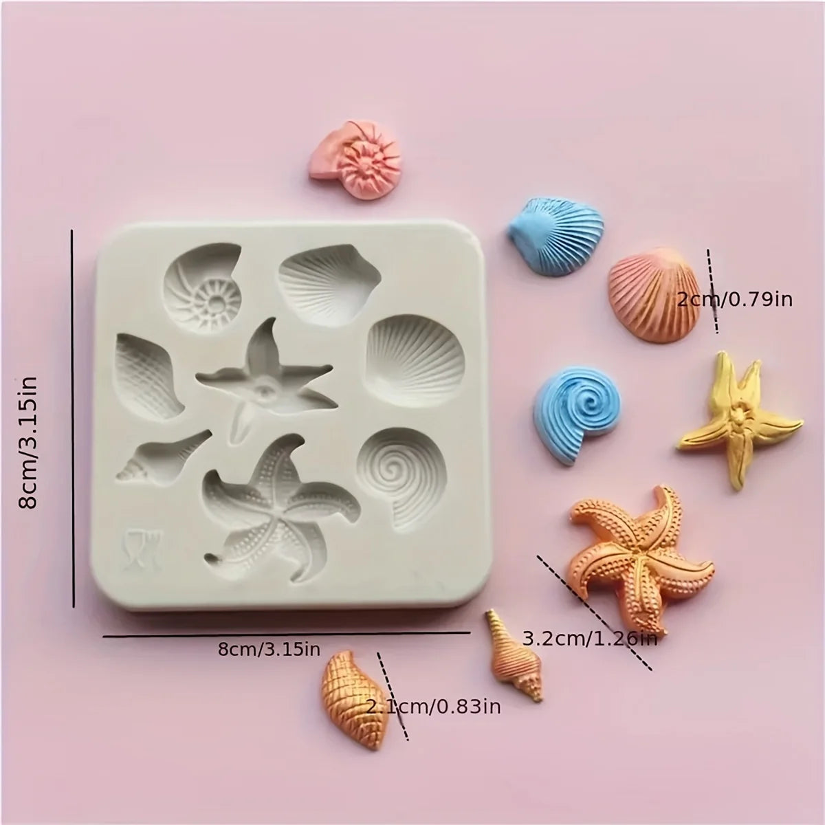 A set of pink and blue silicone baking molds shaped like seashells, starfish, and spirals.