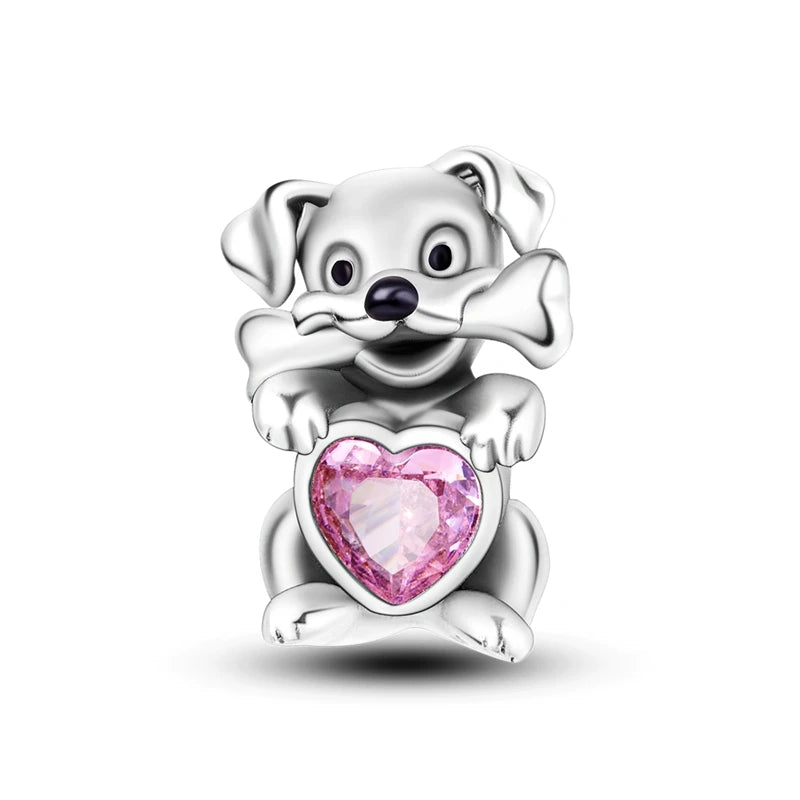 A sterling silver dog charm featuring a heart-shaped bead with pink zircon stones.