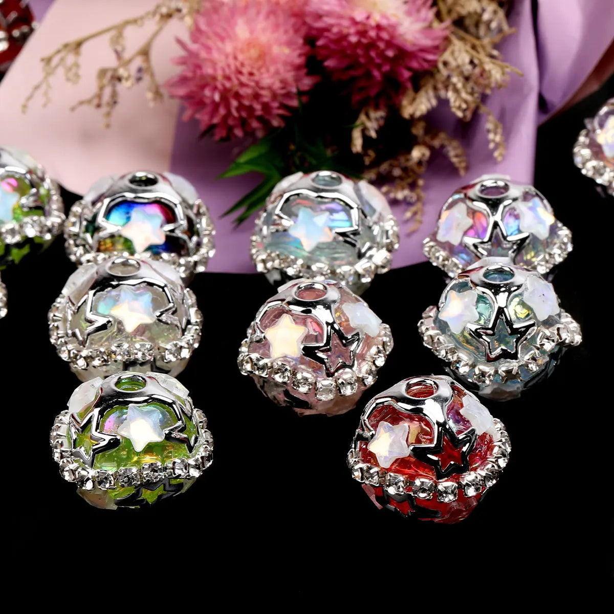 Silver star rhinestone acrylic beads for jewelry making displayed on a black background