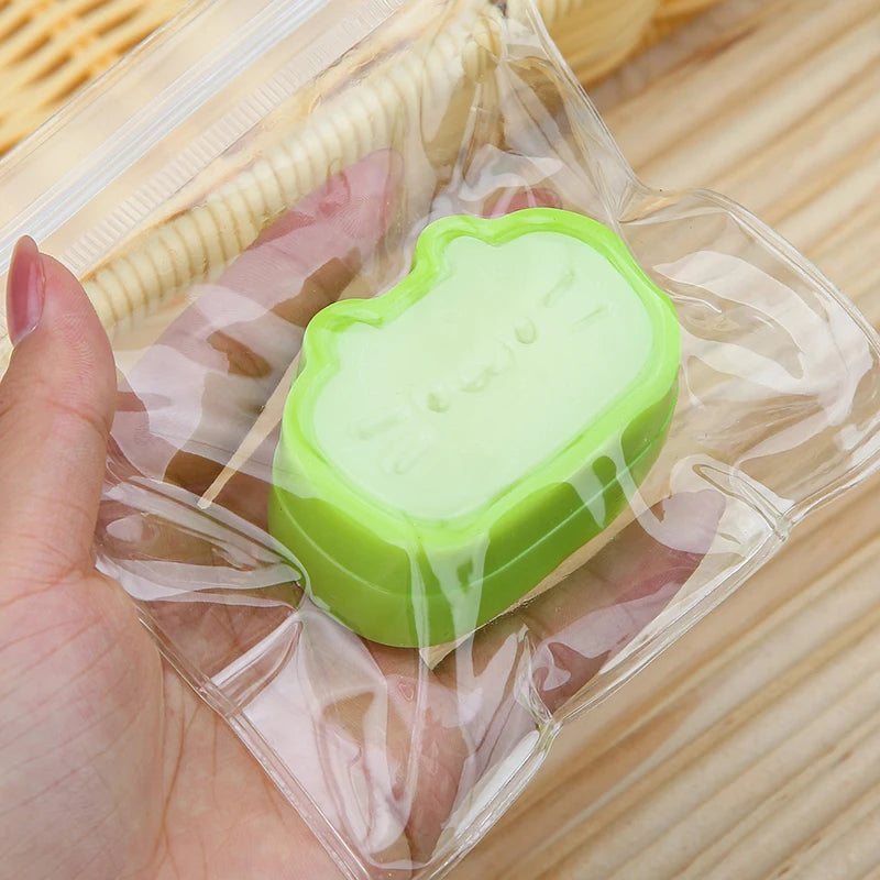 A hand holds a light green squishy stress-relief toy in clear plastic packaging.
