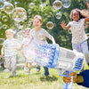 Children playing outdoors while a bubble gun sprays bubbles in the air