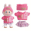 A pink knitted outfit set for a doll figure including a hat, sweater, and matching gloves.