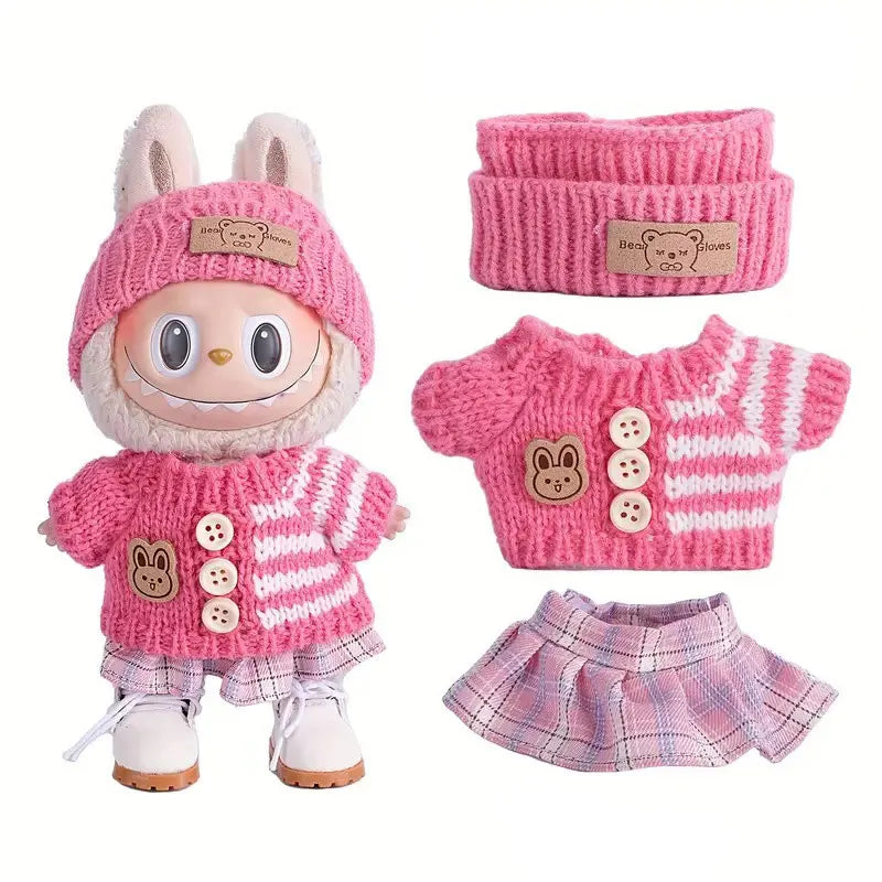 A pink knitted outfit set for a doll figure including a hat, sweater, and matching gloves.
