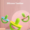 A silicone teether in lime green is shown with a pink ring and pacifier tool on a white surface.