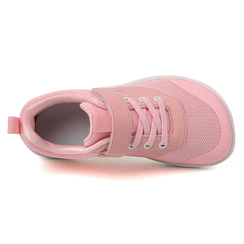 Pink kids barefoot training sneakers with white laces and light gray lining