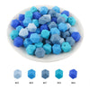A collection of 15 hexagonal silicone beads in various shades of blue and light blue.