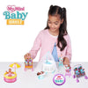 A girl holds a My Mini Baby Series 2 collectible mystery toy set featuring dolls and accessories.