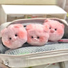Three pink plush pig keychains are displayed inside a light-colored zippered pouch.