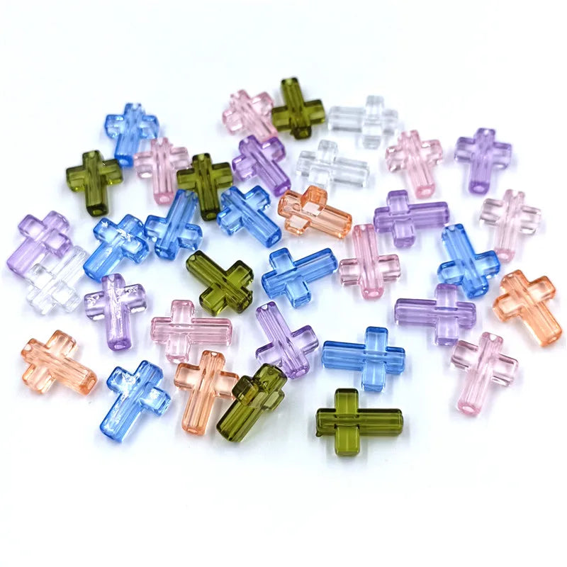 A collection of colorful acrylic cross beads in shades of blue, pink, and green for jewelry making.