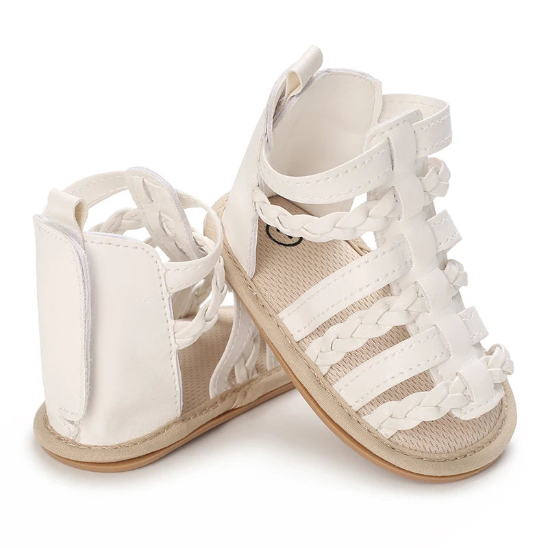 A pair of white breathable baby first walker sandals with a soft anti-slip sole.