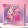 A pink box of Squishy Fun Box containing a pink squishy toy and a pink stress relief toy.