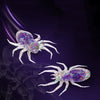 Two realistic spider soft bait lures with iridescent glitter and white legs against a dark purple background.