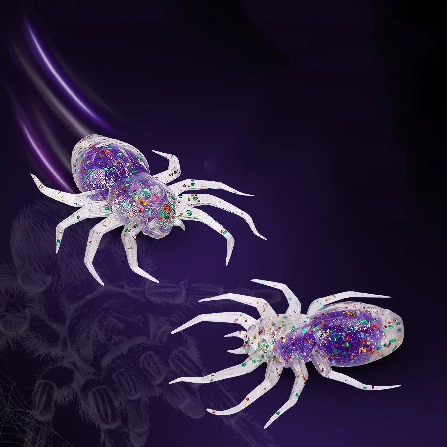 Two realistic spider soft bait lures with iridescent glitter and white legs against a dark purple background.