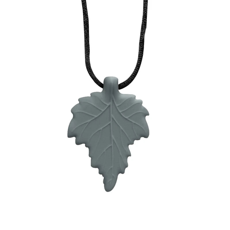 A silicone leaf-shaped necklace with a black cord for teething and sensory calming.