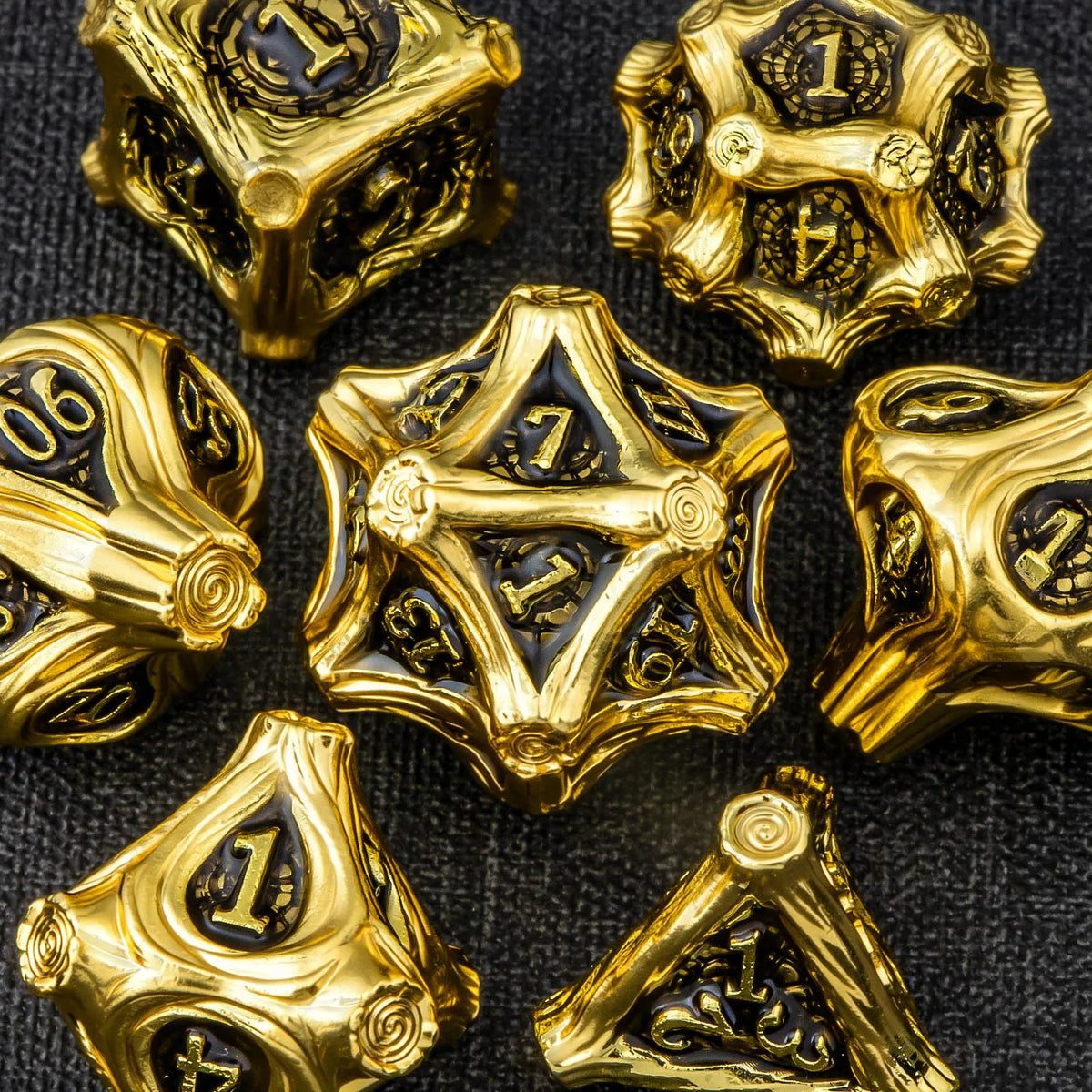 A collection of gold-colored polyhedral dice, including a d10 and d12, set against a dark background.