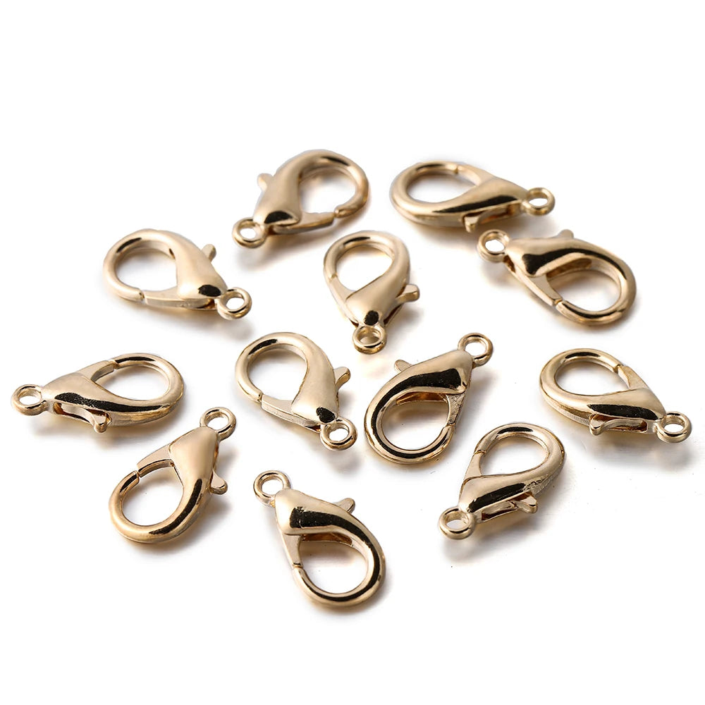 A collection of gold-colored metal lobster clasps for jewelry making.