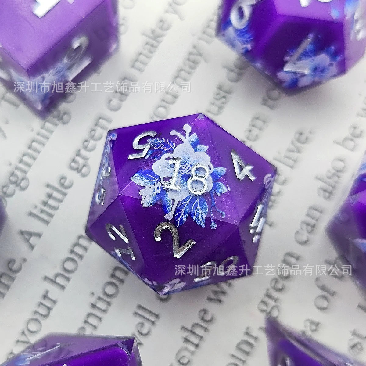 A purple resin die with a blue kitten design resting on white paper.