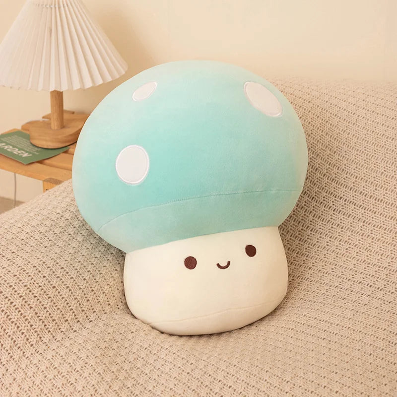 A soft, light blue and white mushroom plush pillow with a smiling face resting on a beige fabric surface.