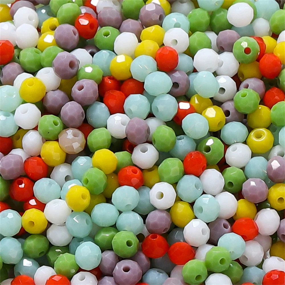 Mixed color faceted rondelle glass beads in various shades of green, yellow, pink, and white for jewelry making