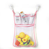 A pink mesh storage bag with suction cups holds various toiletries and yellow duck and frog toys.