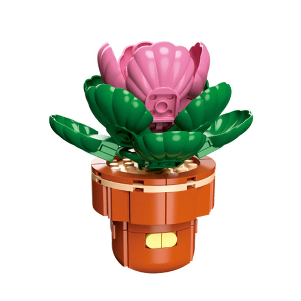 A pink flower-shaped building block with green leaves is mounted on an orange base.