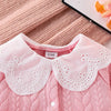 Pink quilted baby girl romper with a white lace collar and pink fabric
