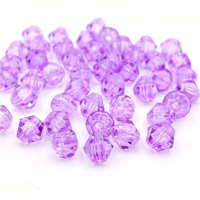 A pile of faceted purple bicone crystal glass beads for jewelry making