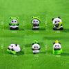 A set of adorable resin panda figurines in various sizes and colors displayed on a green surface.