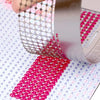 Stainless steel cross ruler used for diamond painting, showing a close-up of the tool and pink beads.