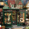 A miniature dollhouse DIY assembly kit for cozy bedroom decor featuring a green shop facade and display windows.