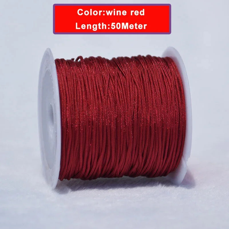 A spool of 50 meter, 0.8mm wine red nylon knotting cord for jewelry making.