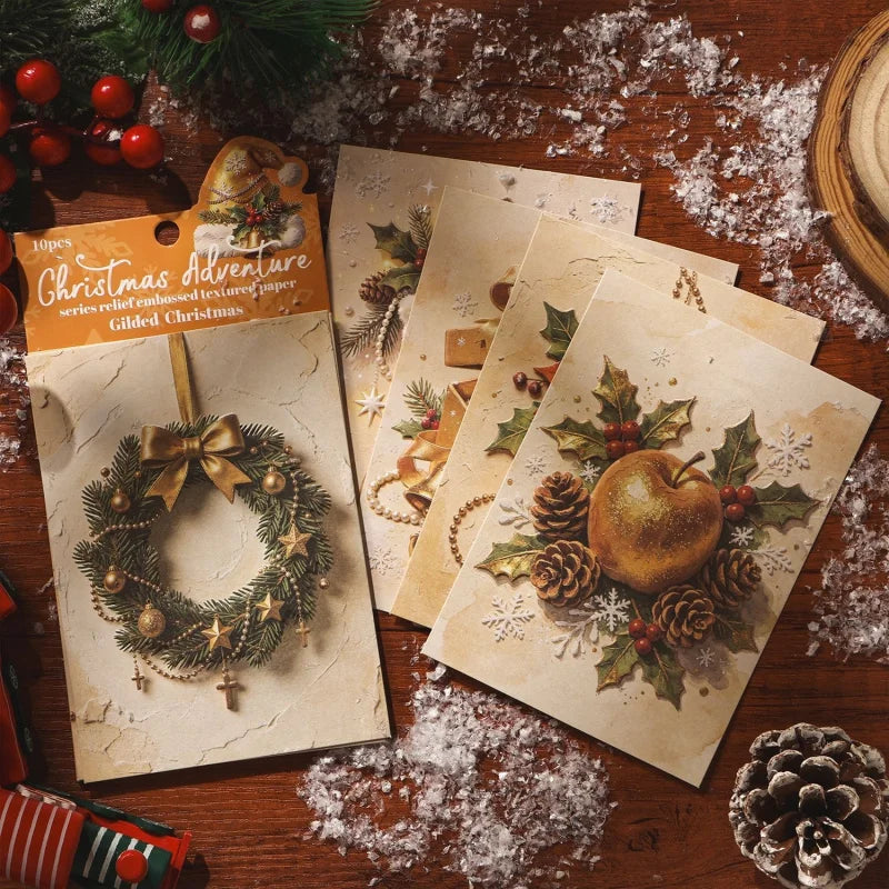 A pack of ten sheets of embossed Christmas adventure decorative paper featuring holiday designs and gilded Christmas themes.