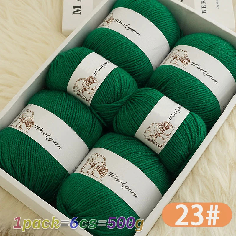 A box containing six balls of green wool yarn for knitting