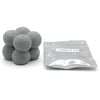 A pile of gray candle dye chips in a sealed plastic bag labeled brown black