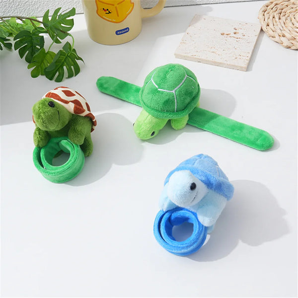 A collection of soft plush turtle bracelet charms, including a green turtle, a striped turtle, and a blue turtle.