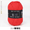 A ball of bright red milk cotton yarn for knitting and crochet