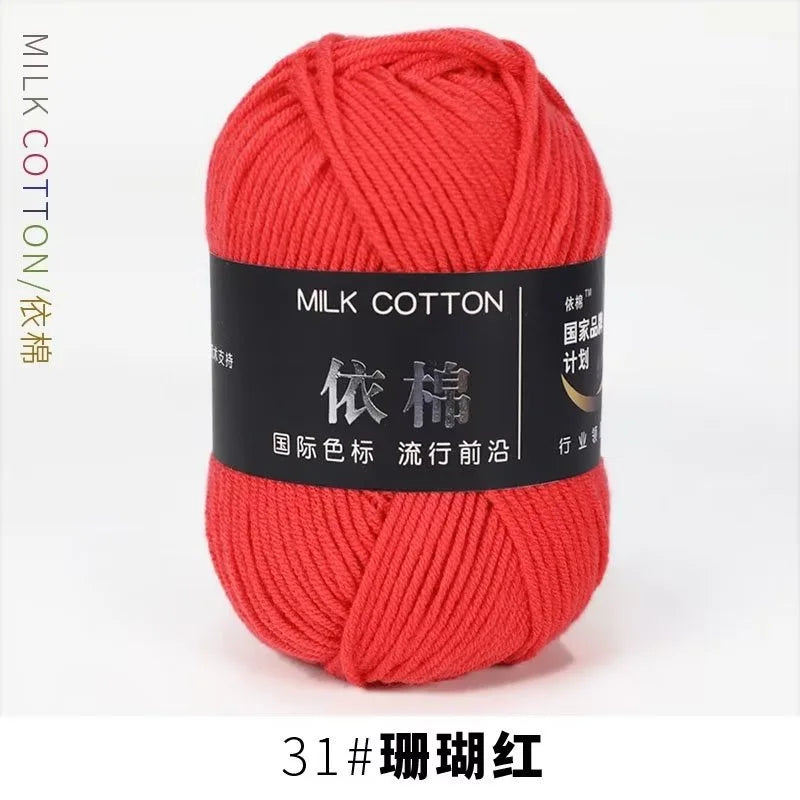 A ball of bright red milk cotton yarn for knitting and crochet