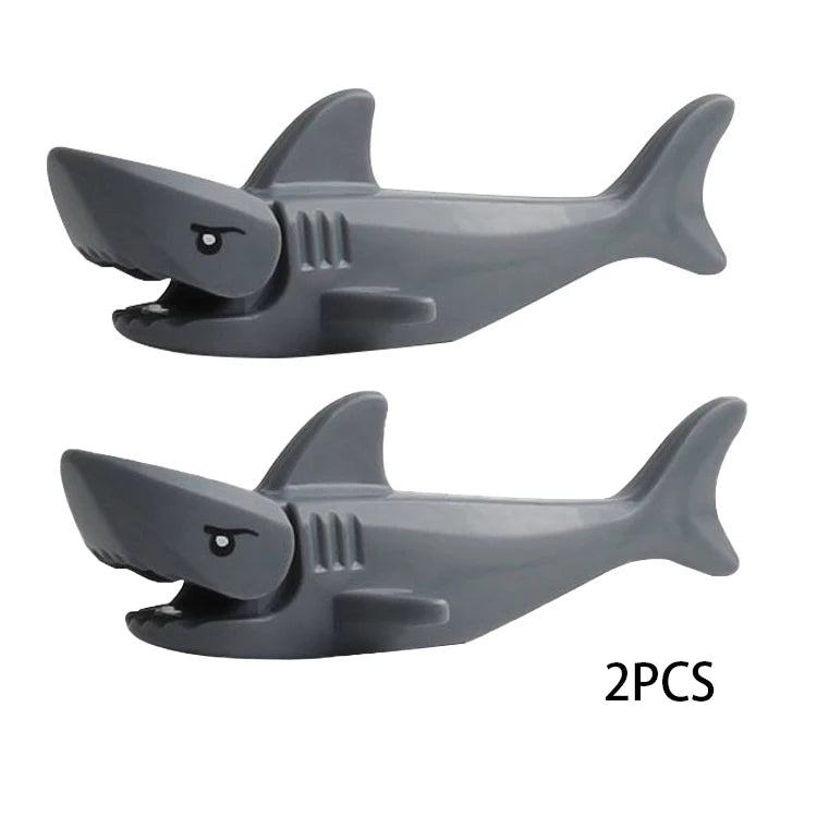 Two gray plastic shark building blocks for marine animal sets