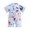 A baby rash guard swimsuit with short sleeves featuring a floral pattern in blue, pink, and white.
