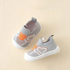 A pair of gray and orange breathable anti-slip baby first walker shoes shown from above.