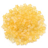A pile of small, yellow transparent star-shaped acrylic beads for jewelry making.