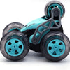 A teal and black remote control stunt car with five wheels is shown from the side.