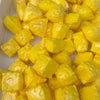 A pile of yellow, squishy cheese balls used as a stress relief squeeze toy.