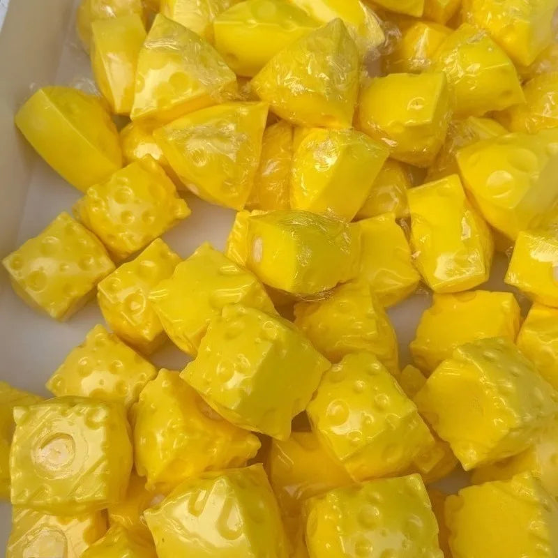 A pile of yellow, squishy cheese balls used as a stress relief squeeze toy.